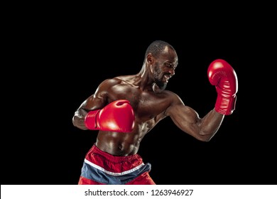 Hands of boxer over black background. Strength, attack and motion concept. Fit african american model in movement. Afro muscular athlete in sport uniform. Sporty man during boxing - Powered by Shutterstock