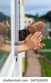 Hands Of A Boy And An Old Man Clapping From The Window To Congratulate The Good People