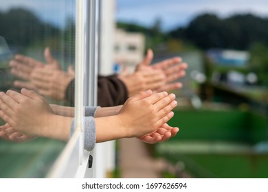 Hands Of A Boy And An Old Man Clapping From The Window To Congratulate The Good People