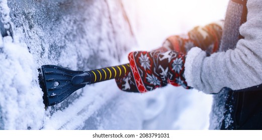 Hands With Brush Clean Car Window From Snow In Winter Time. Windshield Cars Cleaning. Removing Snow From Windows.