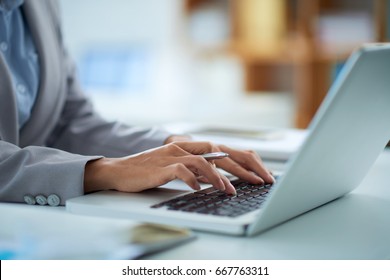 Hands of business lady working on laptop