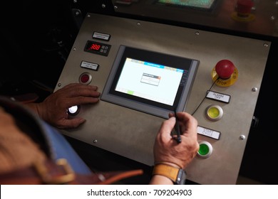 Hands of business owner using interface of modern coffee roaster