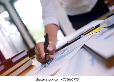 Hands of business people analyzing chart Finance managers task. - Shutterstock ID 733665775