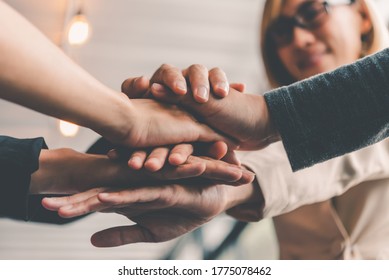  Hands Of Business People Come Together In A Stack Of Hands To Symbolize Collaboration, Teamwork To Achieve Goals And Success.