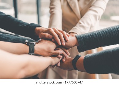  Hands Of Business People Come Together In A Stack Of Hands To Symbolize Collaboration, Teamwork To Achieve Goals And Success.