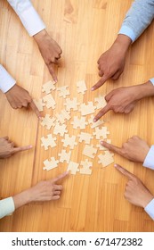 Hands Of Business People Putting Pieces Of Puzzle Together