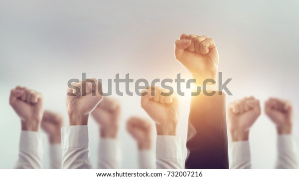 Hands of\
Business team raised fist air Corporate Celebration victory,\
success and winning concept. sunlight\
effect.