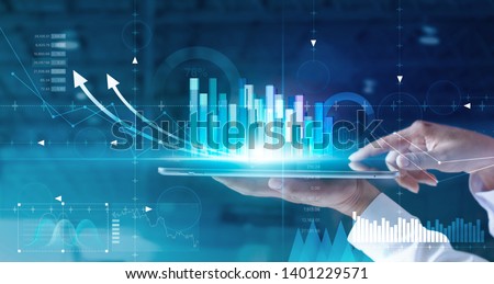 Hands of businessman analyzing sales data and economic growth graph chart on tablet and hologram screen. Business strategy and digital data, business technology, digital marketing.