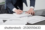 The hands of a businessman checking documents in a hurry