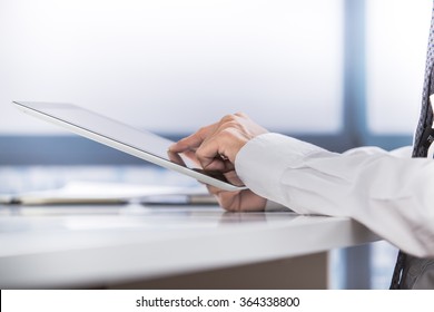 Hands Of Businessman Holding Touchpad With Electronic Document