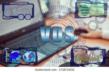 Hands of a businessman using a laptop with smart phone and futuristic holographic screen in the graphs of the exchange rate and the inscription: VDS. Virtual Dedicated Server concept.