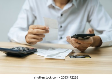 Hands Of Businessman Using Mobile Smart Phone For Scan And Payment Online With Family Budget Cost Bills On Desk In Home Office, Plan Money Cost Saving, Investment, Business Finance, Expenses Concept