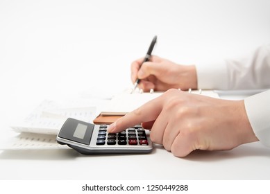 Hands of businessman writing a receipt on a notebook, close-up. - Shutterstock ID 1250449288