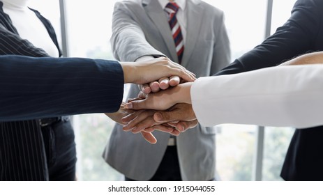 Hands Of Businesspeople Stacked Together In The Symbol Of Unity And Trust In Same Team