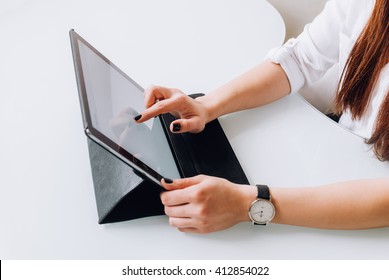 Hands of a businesswoman in her office working with a tablet , side view closeup - Shutterstock ID 412854022