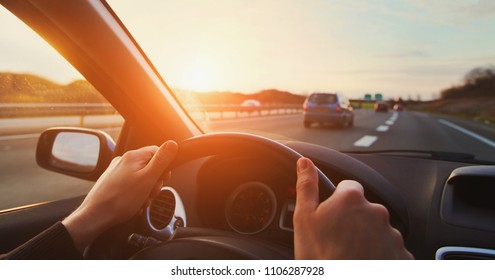 hands of car driver on steering wheel, road trip, driving on highway road - Powered by Shutterstock