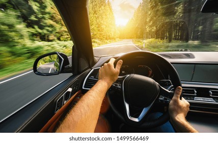 Hands Of Car Driver On Steering Wheel, Driving Car At Summer Day On A Country Road, Having Fun Driving The Empty Highway On Tour Journey - POV, First Person View Shot