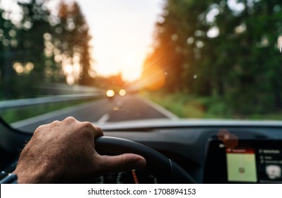 Hands Of Car Driver On Steering Wheel, Fast Driving Car At Spring Day On A Country Road, Having Fun Driving The Empty Highway On Tour Journey - POV First Person View Shot