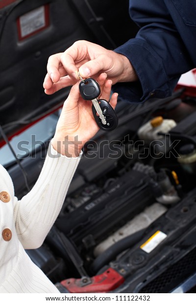 Hands with a Car
keys. Auto repair
service.