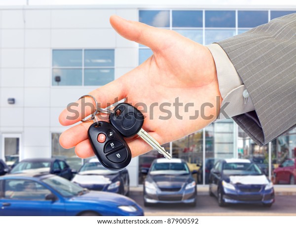 Hands with car keys.\
Dealer and client.
