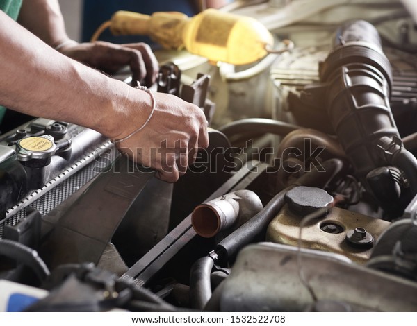 Hands of car mechanic holding the fan of Radiator\
in garage. Car repair