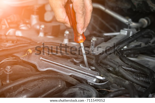 Hands of car mechanic with tool wrench for auto\
repair service.