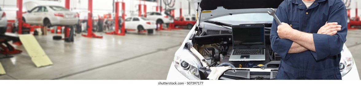 Hands of car mechanic with wrench in garage. - Shutterstock ID 507397177