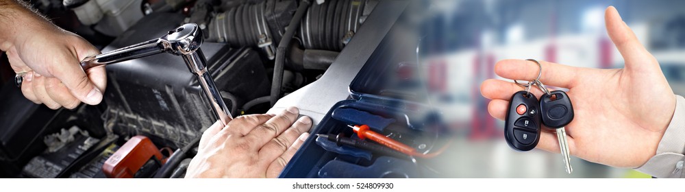 Hands Of Car Mechanic With Wrench In Garage.