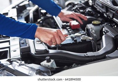 Hands of car mechanic with wrench in garage. - Shutterstock ID 641894500