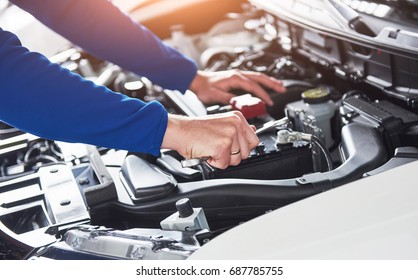 Hands of car mechanic with wrench in garage - Shutterstock ID 687785755