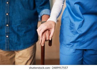 Hands, caregiver and senior man with cane for walking support, help and balance of rehabilitation recovery. People, patient and male person with disability, physiotherapy and mobility on retirement - Powered by Shutterstock