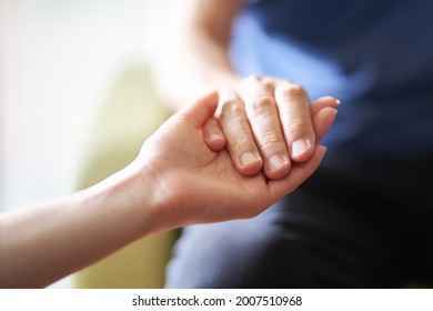 Hands of caregivers and the elderly