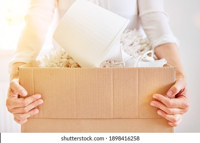 Hands carry full moving boxes when tidying up and mucking out before moving - Shutterstock ID 1898416258