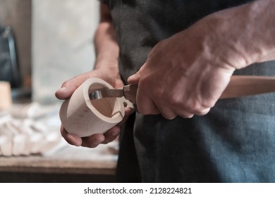 Hands carving cup from wood, working with chisel close up. Wooden workshop. Process of making wooden kitchenware  - Powered by Shutterstock