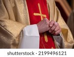 Hands of a Catholic priest in a cassock