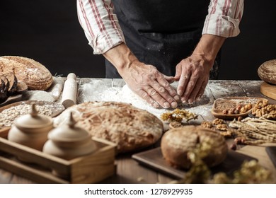 Hands of caucasian man prepares pastry by himself, close up. Man kneads dough on wooden counter with flour and rolling pin, baking organic bread or delicious bun. - Powered by Shutterstock