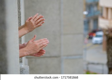 Hands Of Caucasian People Applauding In Window From Apartment. Family Supporting Of Medical Staff, Health Workers During Coronavirus Pandemic In Europe. People Clapping Hands On Street Background.