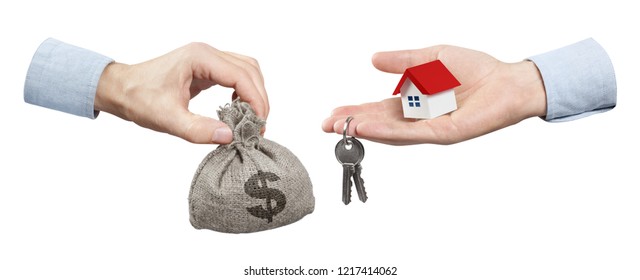 Hands changing a burlap sack full of dollars for keys from a small red-roofed house, isolated on white background