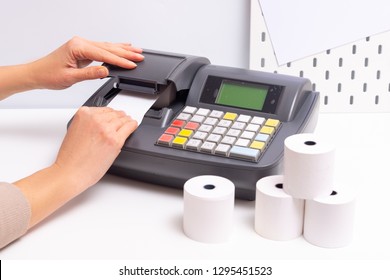 Hands Changing Roll In Cash Register