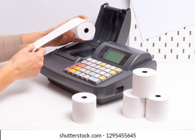 Hands Changing Roll In Cash Register