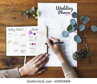 Hands Checking on Wedding Planner Notebook