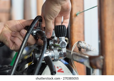 Hands Checking Scuba Gear Tank Regulator