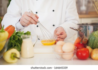 Hands Of A Chef Making An Omelette.