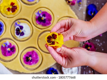 The Hands Of The Chef Spread A Bud Of Pansy Flowers On The Cookie Dough Pieces. Edible Color In Kulnaria Concept