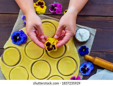 The Hands Of The Chef Spread A Bud Of Pansy Flowers On The Cookie Dough Pieces. Edible Color In Kulnaria Concept