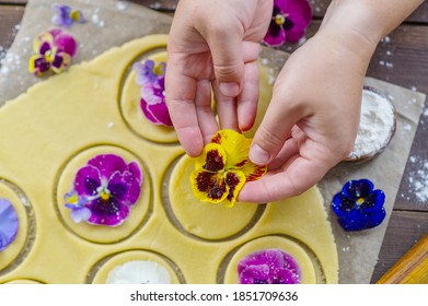 The Hands Of The Chef Spread A Bud Of Pansy Flowers On The Cookie Dough Pieces. Edible Color In Kulnaria Concept