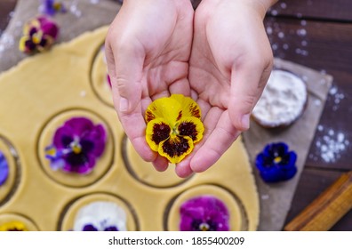 The Hands Of The Chef Spread A Bud Of Pansy Flowers On The Cookie Dough Pieces. Edible Color In Kulnaria Concept