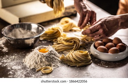 Hands of a chef twisting fettuccine pasta into nests after making a fresh dough from the ingredients. - Powered by Shutterstock