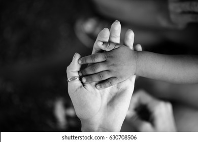Hands of child and adult. Black and white hand. Trust and support, motherhood and childhood, parent and son or daughter. Children of Africa. Family and love between mother and child