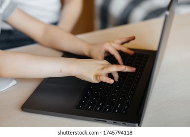 Hands of a child close-up on the laptop keyboard. Distance learning. Stay at home - Powered by Shutterstock